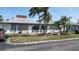 Charming single-story home with a well-maintained lawn, palm trees, and a cozy patio area for outdoor enjoyment at 4329 Tahitian Gardens Cir # B, Holiday, FL 34691