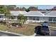 Aerial view of a well-maintained condo with a gray truck parked in front and a neatly landscaped yard at 4329 Tahitian Gardens Cir # B, Holiday, FL 34691