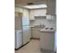 Bright kitchen with white appliances, plenty of cabinet space, and a clean, functional layout perfect for cooking at 4329 Tahitian Gardens Cir # B, Holiday, FL 34691