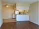 Open-concept kitchen featuring white cabinets, appliances, and a breakfast bar that seamlessly connects to the living area at 4329 Tahitian Gardens Cir # B, Holiday, FL 34691