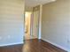 Spacious bedroom with laminate flooring and access to bathroom at 4329 Tahitian Gardens Cir # B, Holiday, FL 34691