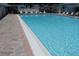 Sparkling pool with clear blue water and lounge chairs for relaxing poolside at 4329 Tahitian Gardens Cir # B, Holiday, FL 34691