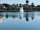 Picturesque water view with palm trees and a tranquil fountain. Relaxing waterside setting at 4329 Tahitian Gardens Cir # B, Holiday, FL 34691