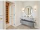 Bathroom with double sink vanity, modern lighting, and views into walk-in closet at 1630 Douglas Ave, Dunedin, FL 34698