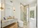 Stylish bathroom featuring marble vanity, glass-enclosed shower, and modern fixtures with clean lines and bright lighting at 1630 Douglas Ave, Dunedin, FL 34698
