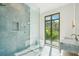 The bathroom features a glass shower and a toilet room, large window and vanity at 1630 Douglas Ave, Dunedin, FL 34698