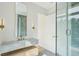 Modern bathroom featuring a marble vanity top, floating cabinet, and a glass enclosed shower at 1630 Douglas Ave, Dunedin, FL 34698