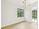 Bedroom featuring a modern light fixture and a large window to bring in natural light at 1630 Douglas Ave, Dunedin, FL 34698