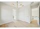 Bedroom with hardwood floors and modern lighting, with bathroom and hallway access at 1630 Douglas Ave, Dunedin, FL 34698