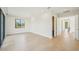 Bright bedroom featuring hardwood floors, recessed lighting and access to a hallway at 1630 Douglas Ave, Dunedin, FL 34698
