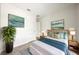 Cozy bedroom featuring stylish decor, a comfortable bed with decorative pillows and side tables with matching lamps at 1630 Douglas Ave, Dunedin, FL 34698