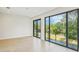 Sun-lit bedroom featuring hardwood floors, recessed lighting, and expansive windows with backyard views at 1630 Douglas Ave, Dunedin, FL 34698
