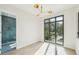 Bedroom featuring a modern light fixture, large window and access to bathroom with glass shower at 1630 Douglas Ave, Dunedin, FL 34698