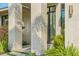 Modern home featuring stone pillars, glass door, and landscaped walkway with stone accents at 1630 Douglas Ave, Dunedin, FL 34698