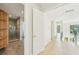 Hallway with doors, recessed lighting, and wood-style floors leading to the rest of the house at 1630 Douglas Ave, Dunedin, FL 34698