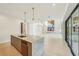 Spacious kitchen island with marble countertop, bar seating, and stainless steel appliances in an open floorplan at 1630 Douglas Ave, Dunedin, FL 34698