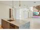 Bright, open kitchen with stainless sink, marble island, modern lighting, and views into the spacious living room at 1630 Douglas Ave, Dunedin, FL 34698