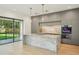 Close up of an open concept Kitchen and dining area with large marble island and state of the art appliances at 1630 Douglas Ave, Dunedin, FL 34698