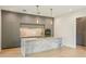 Contemporary kitchen featuring stone countertops, stainless steel appliances, and sleek grey cabinets at 1630 Douglas Ave, Dunedin, FL 34698
