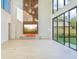 Bright living room with a fireplace and expansive glass doors, creating a seamless indoor-outdoor living space at 1630 Douglas Ave, Dunedin, FL 34698