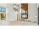 Spacious living room with a wood accent wall and large windows, offering modern elegance and natural light at 1630 Douglas Ave, Dunedin, FL 34698
