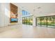 Spacious living area with a contemporary fireplace, large windows, and natural light flowing throughout at 1630 Douglas Ave, Dunedin, FL 34698