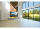 Stylish living room boasting a unique fireplace, large windows overlooking a pool, and hardwood floors at 1630 Douglas Ave, Dunedin, FL 34698