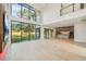 Open-concept living area with soaring ceilings, hardwood floors, and a view of the modern kitchen at 1630 Douglas Ave, Dunedin, FL 34698