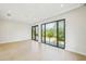 Spacious living room with black trimmed floor-to-ceiling windows bringing the outside in at 1630 Douglas Ave, Dunedin, FL 34698