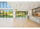Bright living room featuring a soaring ceiling, hardwood floors, modern lighting and floor to ceiling glass doors to the back yard at 1630 Douglas Ave, Dunedin, FL 34698
