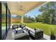 Relaxing outdoor patio area with stylish furniture, lush green lawn, and inviting pool perfect for entertaining and outdoor living at 1630 Douglas Ave, Dunedin, FL 34698