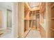 A custom, light-colored wood wardrobe with open shelves and drawers at 1630 Douglas Ave, Dunedin, FL 34698