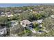 An aerial shot showcasing a new modern home nestled amongst lush greenery, near the water at 1630 Douglas Ave, Dunedin, FL 34698