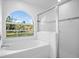 Bathroom with soaking tub, shower, and large window at 2510 Sheila Ln, North Port, FL 34286