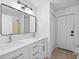 Bathroom with double vanity, modern mirror, and white cabinets at 2510 Sheila Ln, North Port, FL 34286