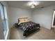 Bright bedroom with a queen bed, tiled floor, and window at 2510 Sheila Ln, North Port, FL 34286
