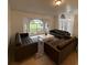Living room with brown couches and a large window at 2510 Sheila Ln, North Port, FL 34286