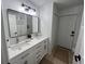 Modern bathroom with double vanity, large mirror, and white cabinets at 2510 Sheila Ln, North Port, FL 34286