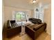 Spacious living room with large windows and brown leather sofas at 2510 Sheila Ln, North Port, FL 34286