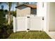 The backyard features new grass and a white gate at 3850 Pompano Se Dr # 2, St Petersburg, FL 33705