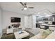 Open living room and kitchen with gray cabinets at 8901 Blind Pass Rd # 228, St Pete Beach, FL 33706