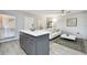 Open concept kitchen and living area with gray cabinets and white sofa at 8901 Blind Pass Rd # 228, St Pete Beach, FL 33706