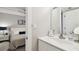 Bright bathroom with a white vanity and a view of the bedroom at 8901 Blind Pass Rd # 228, St Pete Beach, FL 33706