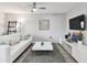 Living room with white couch and modern decor at 8901 Blind Pass Rd # 228, St Pete Beach, FL 33706