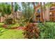 Lush courtyard with tropical landscaping and green grass at 8901 Blind Pass Rd # 228, St Pete Beach, FL 33706