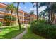 Courtyard with brick pathway, lush landscaping, and seating area at 8901 Blind Pass Rd # 228, St Pete Beach, FL 33706