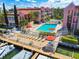 Community pool with sundeck, dock, and waterfront views at 8901 Blind Pass Rd # 228, St Pete Beach, FL 33706