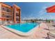 Community pool with spacious sundeck and lounge chairs at 8901 Blind Pass Rd # 228, St Pete Beach, FL 33706