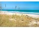 Scenic view of a sandy beach, clear ocean, and lush dunes on a sunny day at 15810 2Nd E St, Redington Beach, FL 33708