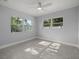 Bright bedroom featuring terrazzo floors, neutral paint, and dual windows with natural light at 15810 2Nd E St, Redington Beach, FL 33708